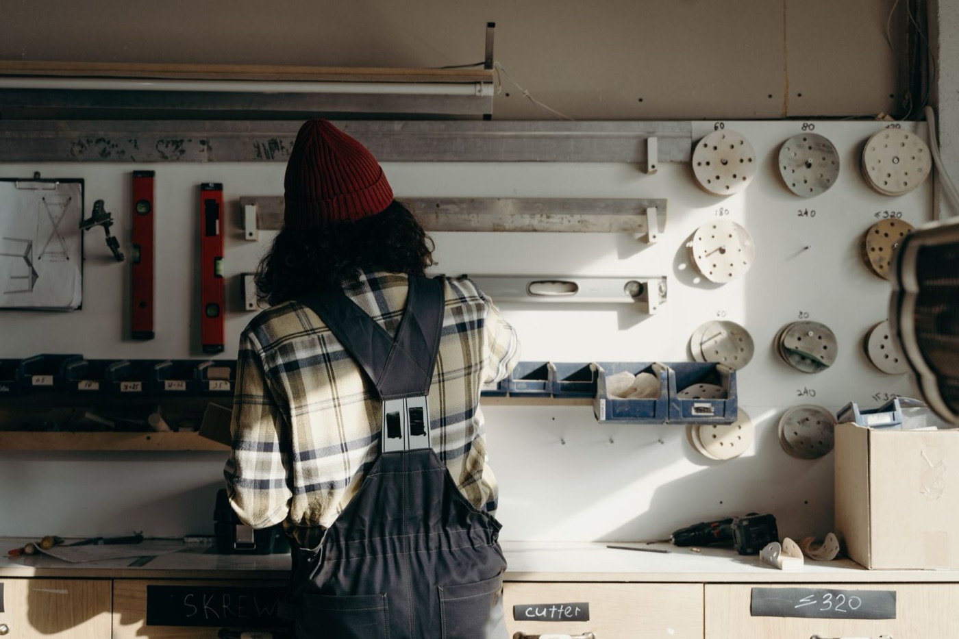 The maker at his bench, seen from behind
