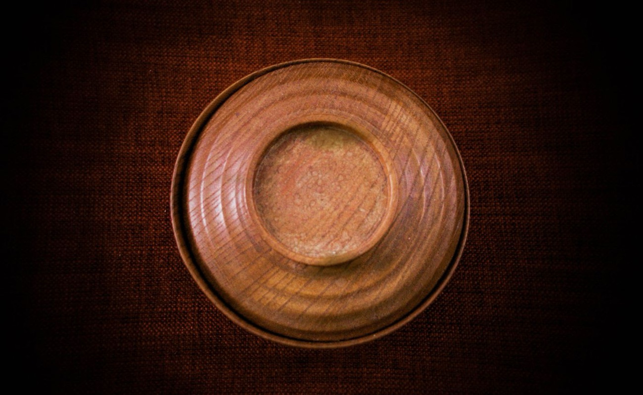 A dark walnut lidded vessel